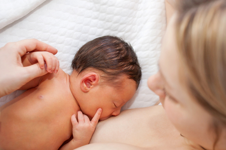 58532477 - newborn baby breastfeeding after birth. mom nursing baby.
